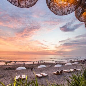 white parasol and lounge near seashores