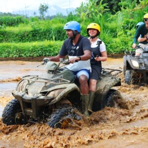 2 men riding atv on dirt road during daytime