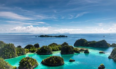 islets surrounded by body of water during daytime